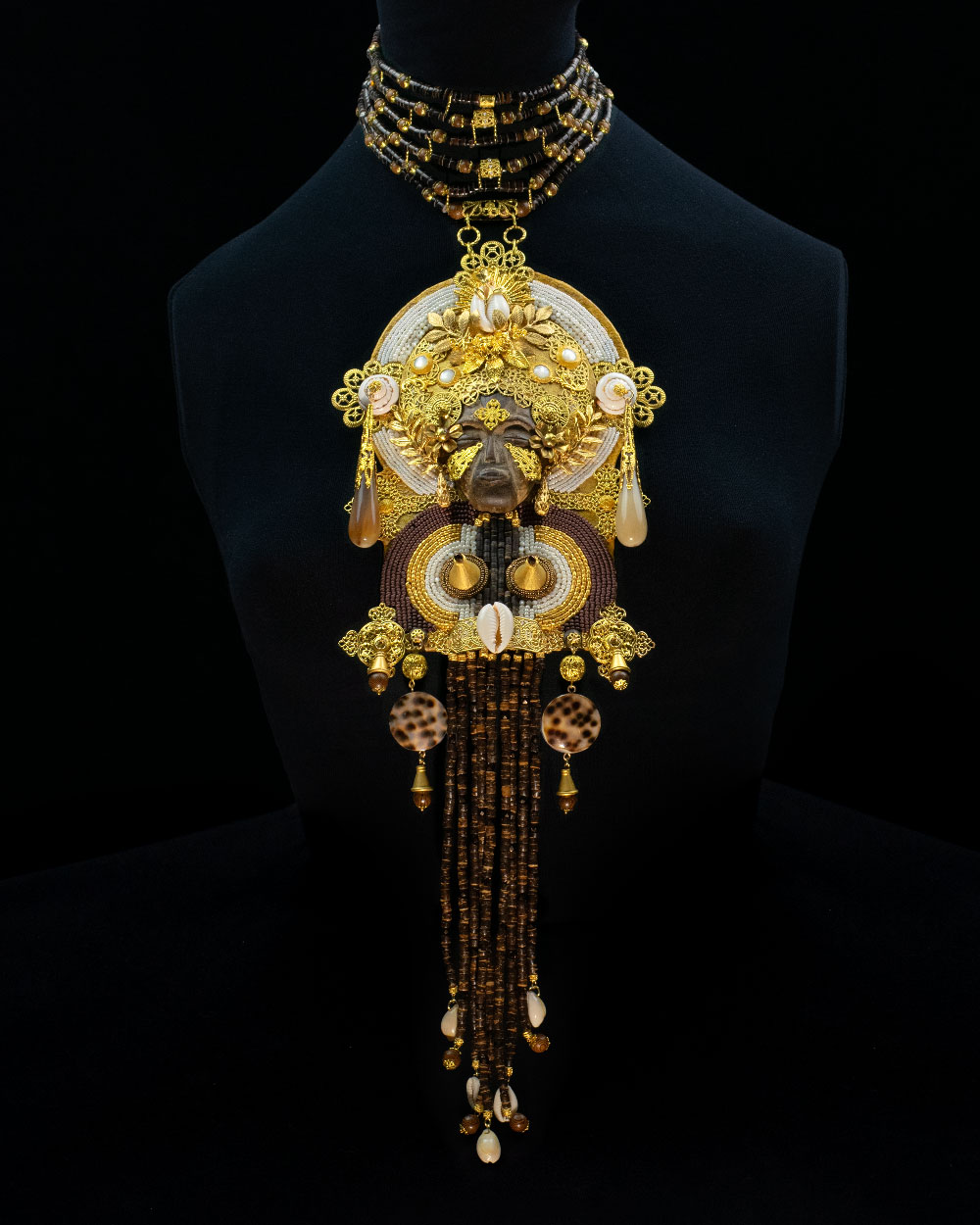 Detail of carved African female mask pendant in dialogue with Madonna iconography, gold filigree and freshwater pearls, Lacrimae Mundi collection