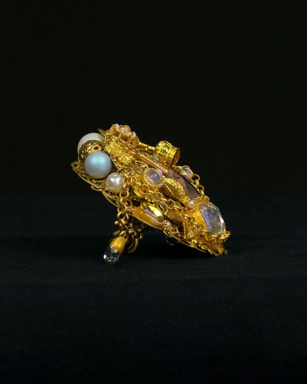 Detail of gold filigree reliquary ring with faceted crystal and freshwater pearls, Queen Swan collection